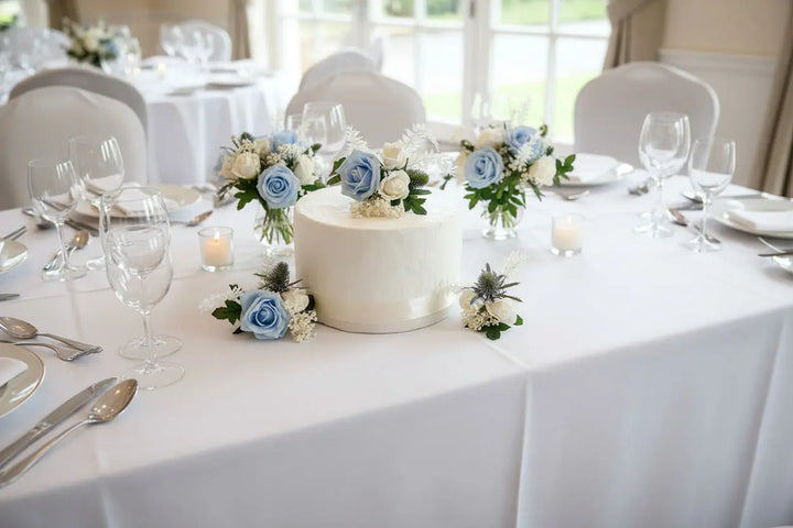 Round cake with white and blue flowers on a white background